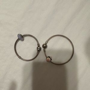 2 pandora silver bracelets.